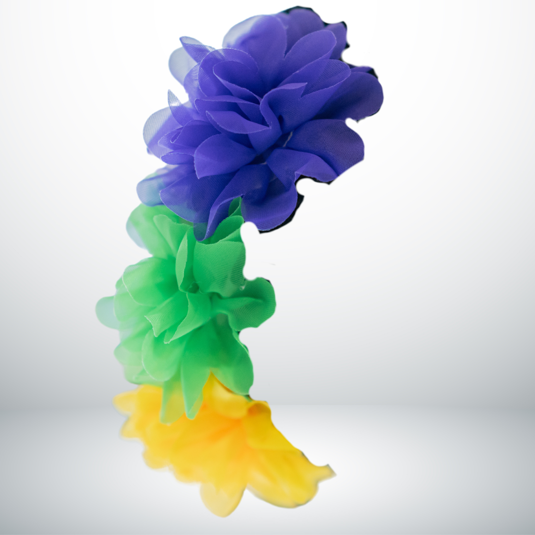 Mardi Gras Floral Headband with purple, green, and gold flowers on a braided hairstyle.