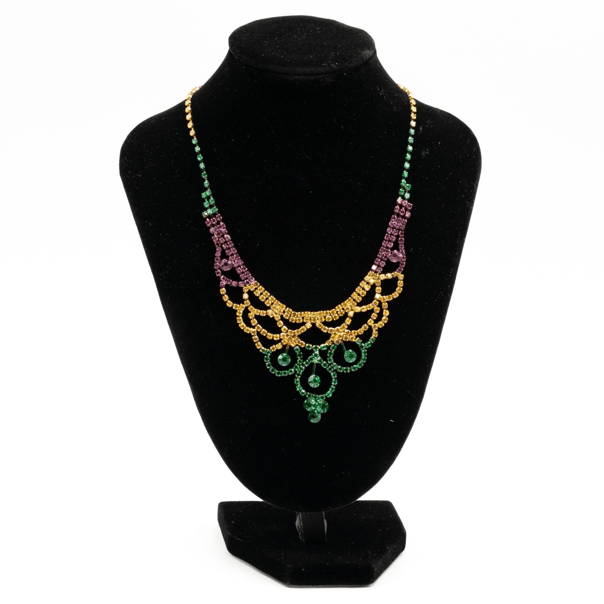 Mardi Gras rhinestone fan necklace in gold, green, and purple with layered fan-like design on a black display.