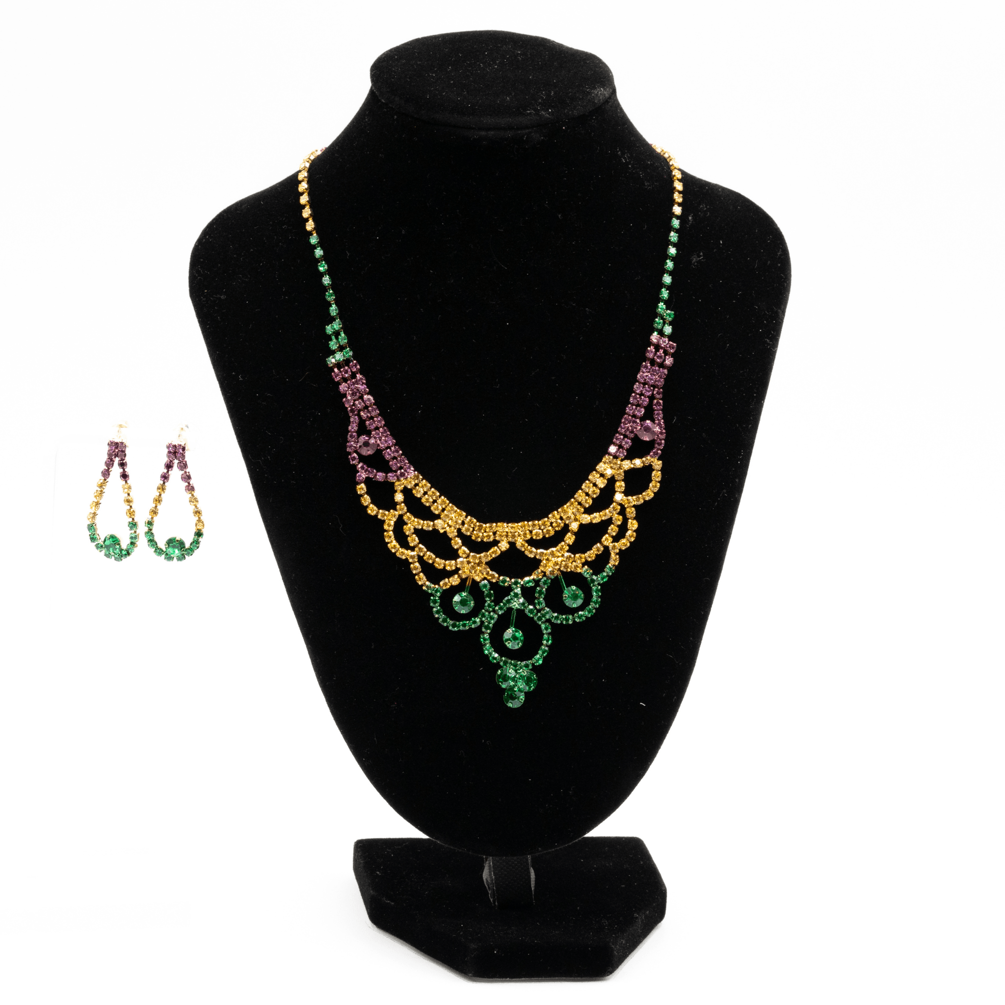 Mardi Gras rhinestone fan necklace in gold, green, and purple with layered fan-like design on a black display.