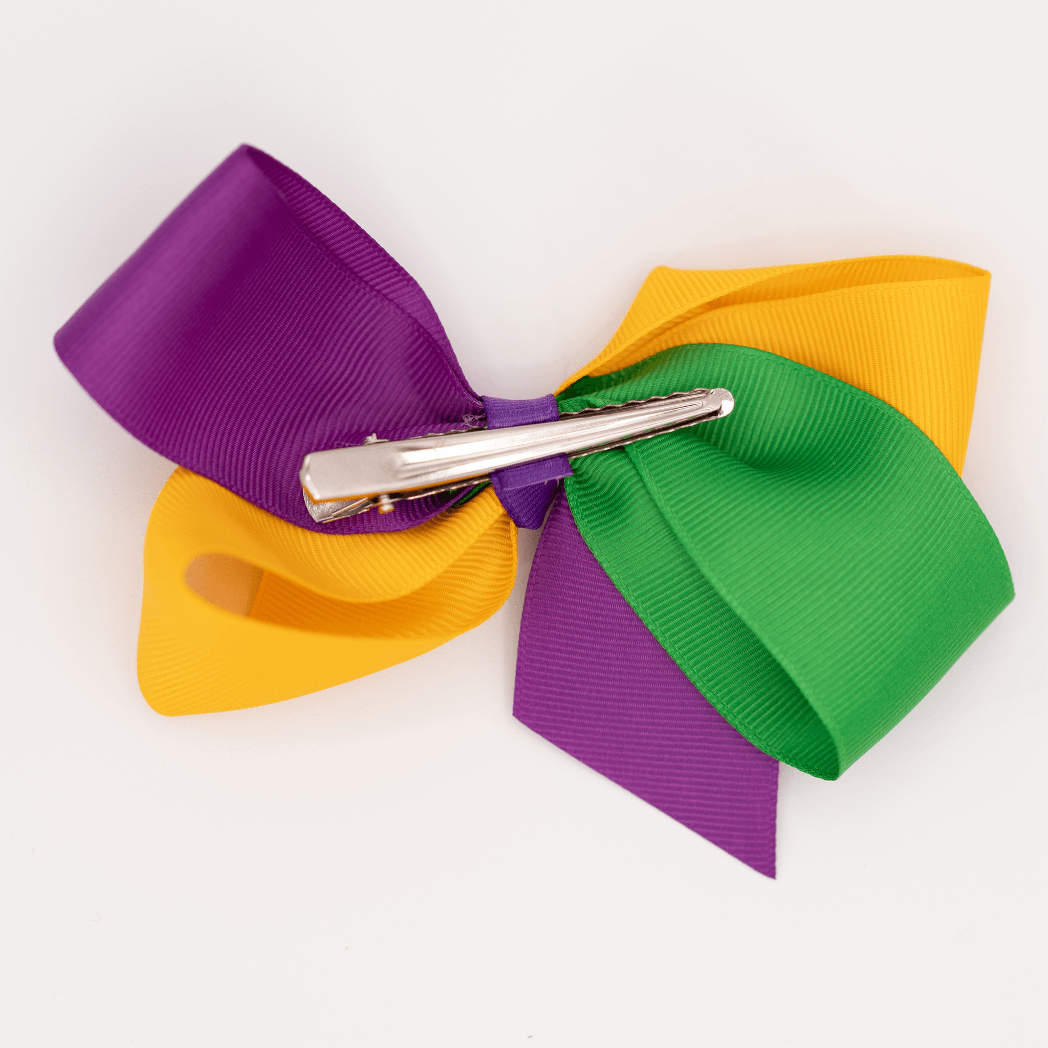 Mardi Gras Ribbon Bow Hair Clip with purple, green, and gold ribbon attached to a sturdy alligator clip, perfect for festive celebrations.