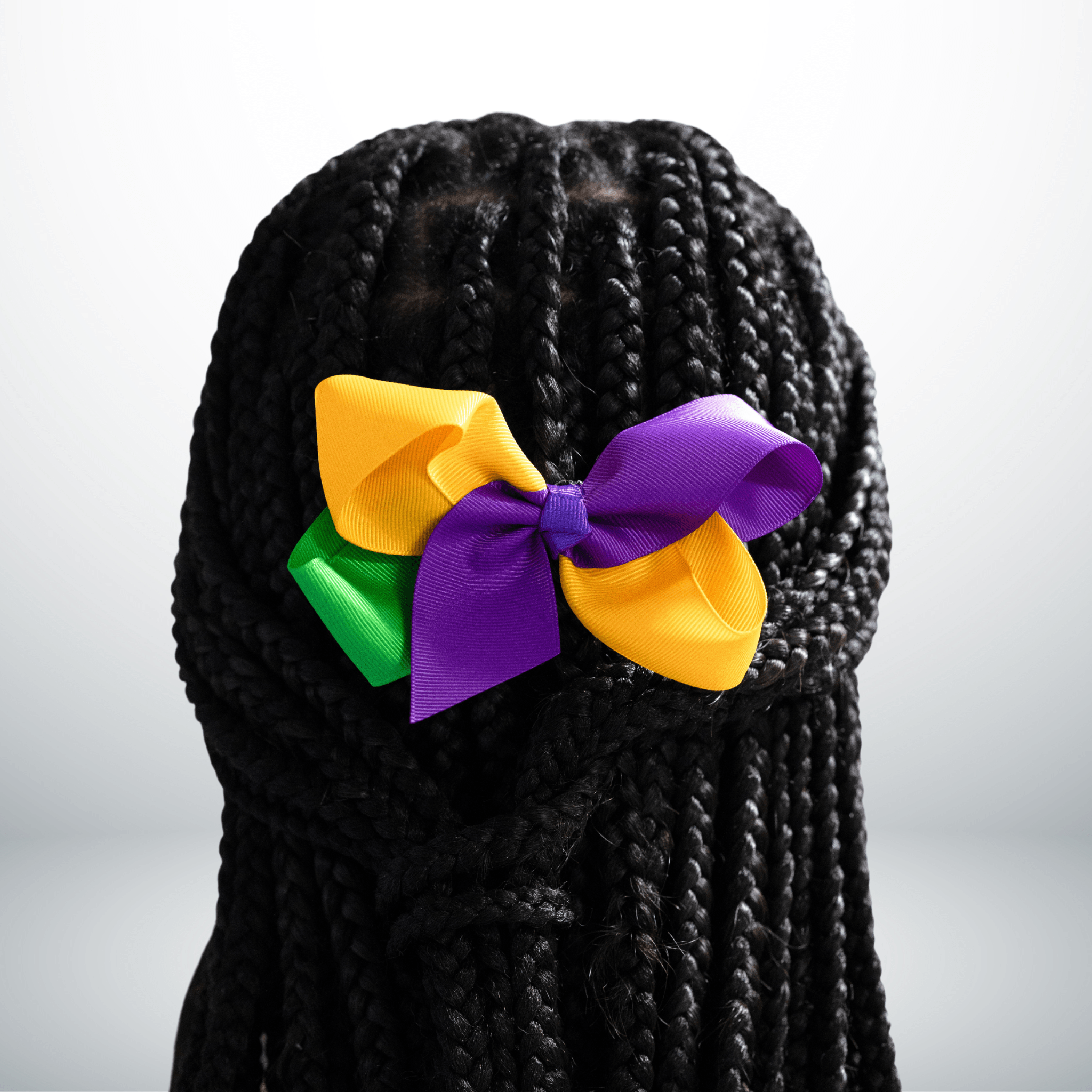 Mardi Gras Ribbon Bow Hair Clip with purple, green, and gold ribbon attached to a sturdy alligator clip, perfect for festive celebrations.