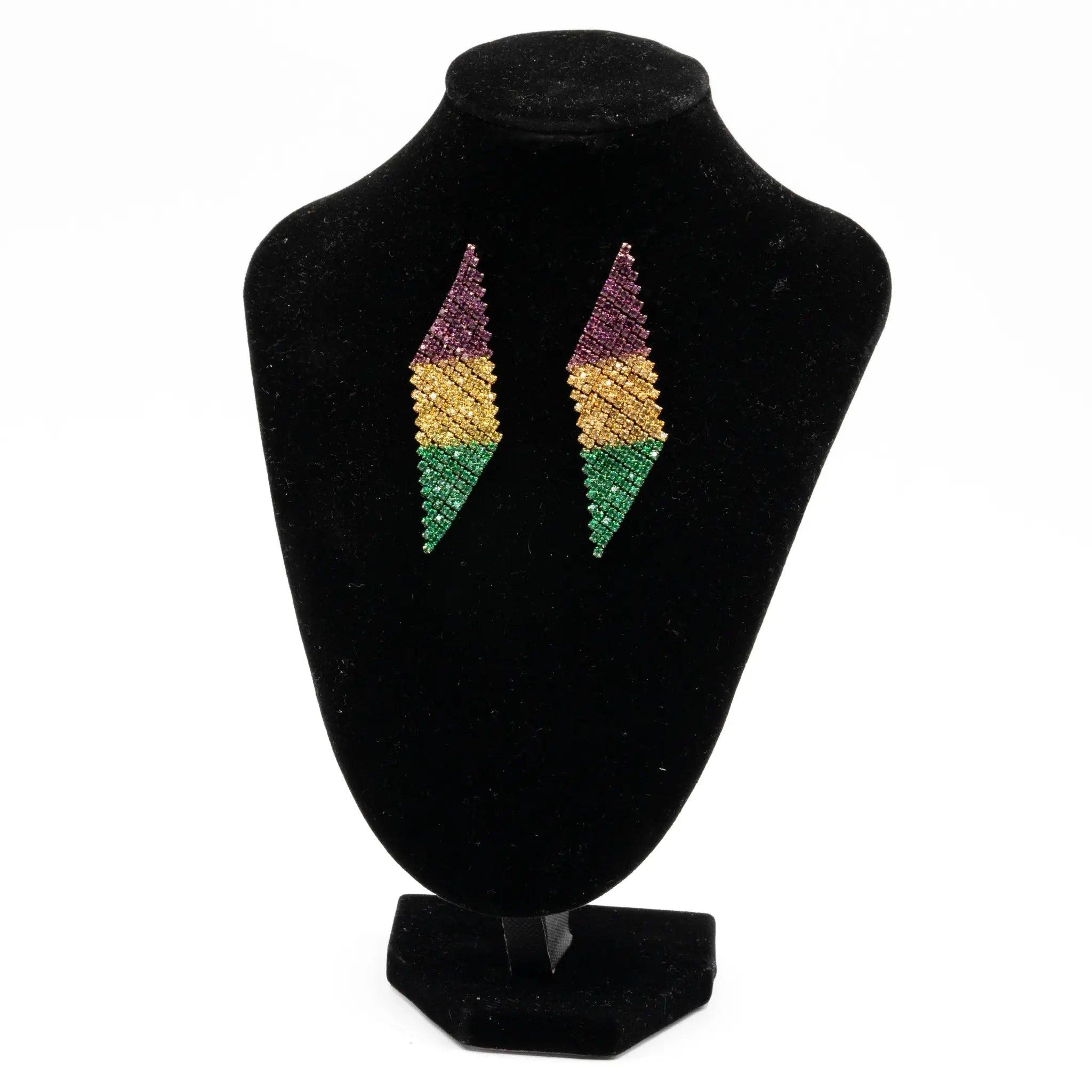 Mardi Gras rhinestone chevron drop earrings in purple, green, and gold displayed on a black stand.