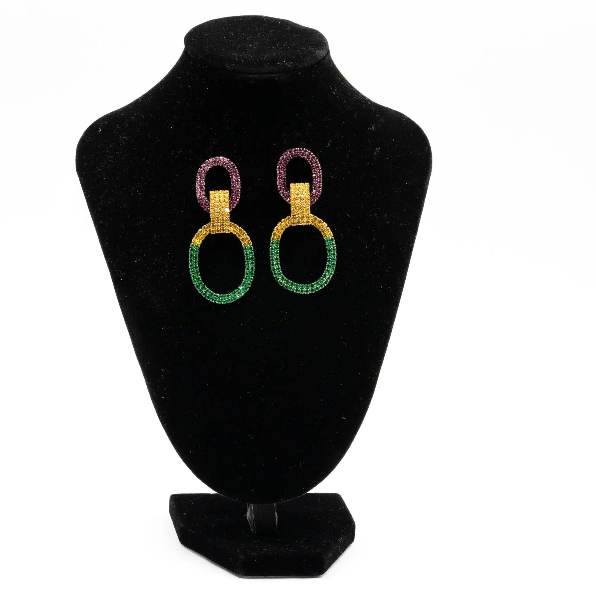 Mardi Gras rhinestone double oval earrings in purple, green, and gold displayed on a black stand.